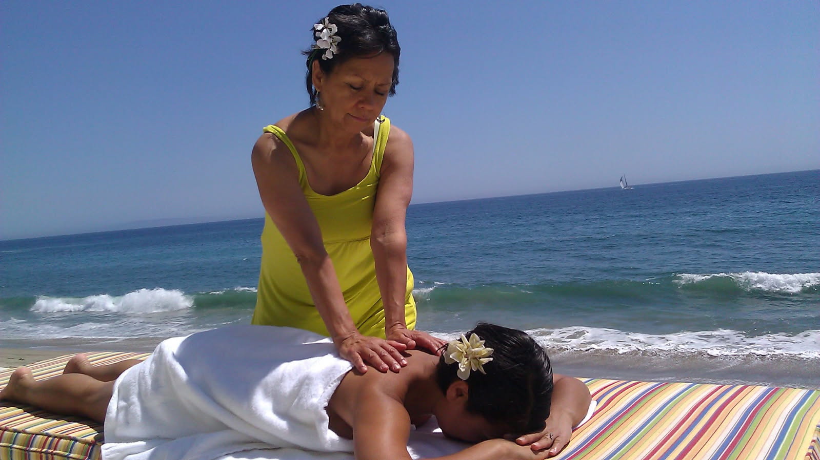 MariCarmen providing a massage beside the ocean